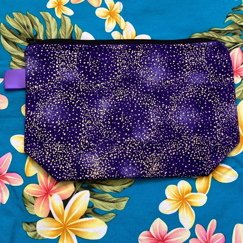 NWOT cloth pouch. 9.5x6.5 inches. Purple and gold.